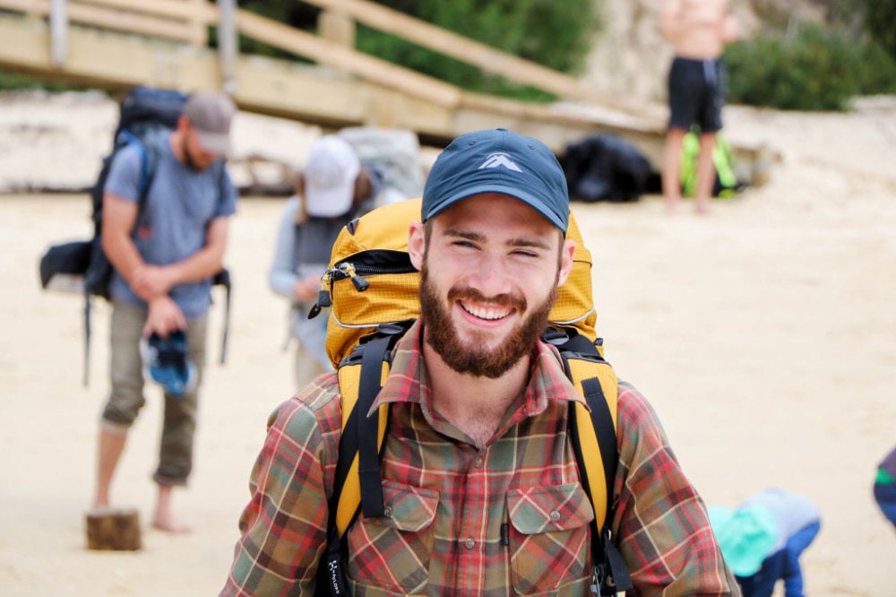 man-smiling-with-backpack
